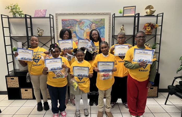  students standing with certificates